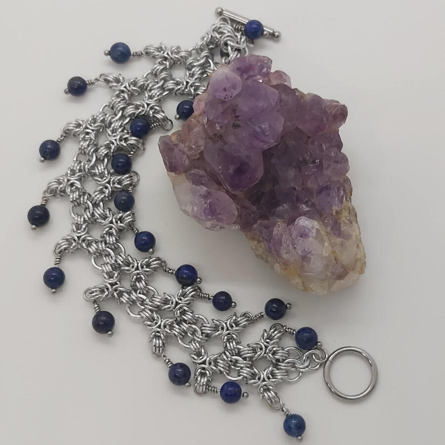 Namaste Tripoli, made with anodized aluminum rings and lapis lazuli beads. Toggle and head pins are stainless steel.
