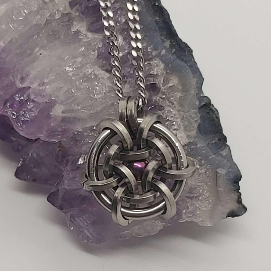 Hoodoo Hex pendant, made with stainless steel and a titanium ball bearing.